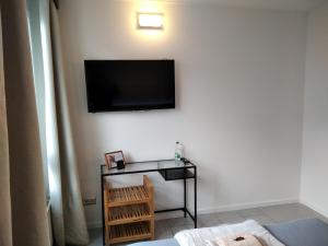 a living room with a television on a wall at Sroom 118 and 119 in Center in Reutlingen