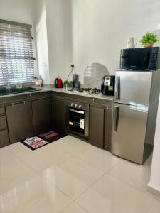 a kitchen with a stainless steel refrigerator and an oven at Sea La Vie Villa in Grande Gaube