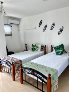 two beds in a room with two at Sea La Vie Villa in Grande Gaube