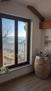 a room with a large window and a barrel at Charming Barolo Wine Loft in Monforte dʼAlba