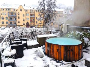 a hot tub on a balcony in the snow at Grosse Wohnung - Balkon,Pool,Garten&Grill - HW1b in Sebnitz