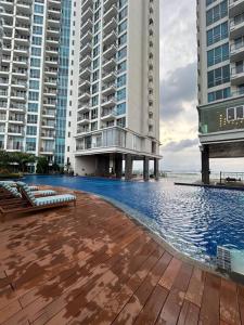 a swimming pool in the middle of two tall buildings at Water Fountain View Ancol Apartment in Jakarta