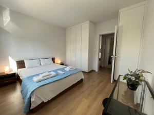 a bedroom with a bed with two towels on it at Prince Boutique Apartment/1BR in Nicosia