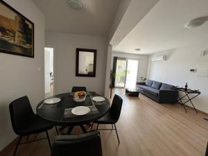 a living room with a table and chairs and a couch at Prince Boutique Apartment/1BR in Nicosia