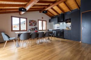 a kitchen with a table and chairs in a room at Le petit Paradis, chalet au coeur des 3 vallées in Saint-Marcel