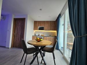 a dining room with a table and chairs and a window at THE CLIFF ALONA in Alona