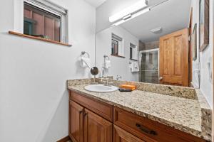 a bathroom with a sink and a mirror at 539 Granite St in Frisco +40 photos
