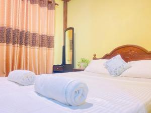 Postel nebo postele na pokoji v ubytování Unakuruwa Ravenala Homestay