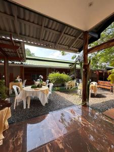 a patio with a table and chairs and a pavilion at Pousada Rekantu do Poeta in Alter do Chao