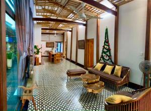 a living room with a couch and a christmas tree at KaoCat Sea Villa w/3BR 2BA AC 3km to DT & NightMK in Phú Quốc