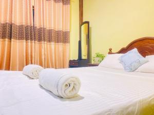 Postel nebo postele na pokoji v ubytování Unakuruwa Ravenala Homestay