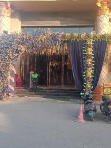 a man standing in front of a building with curtains at HOTEL Seven Heaven -Lawrence Road New Delhi in New Delhi