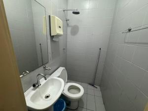 a small bathroom with a toilet and a sink at Mini Ap no derby com Garagem in Sobral