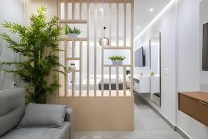a living room with a couch and a tv at Copa Beach Studios Design in Rio de Janeiro