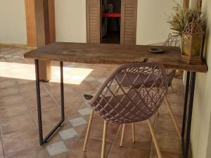 a wooden table with a chair in a room at Chalé ensolarado in Lages