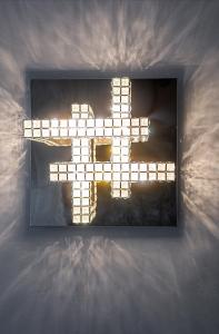 a light up cross on top of a bed at Green Leaf - BillBerry Apartments in Sopot