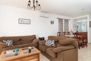 a living room with a couch and a table at Impresionante Villa Son Ganxo II en Cala Murada! in Cala Murada