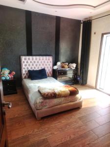 a bedroom with a bed and a table and a window at Villa chadine in Safi