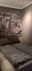 a bedroom with a large picture of a city at Central Grünerløkka, close to city center in Oslo