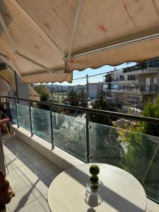 a balcony with a table and a view of a city at Rainbow Floor in Thessaloniki