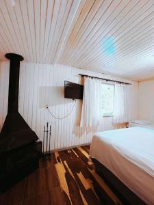 - une chambre avec un lit et une fenêtre dans l'établissement Pousada Quinta dos Medeiros, à Canela