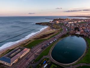 an aerial view of a city and the ocean at Longsands Beach, Apartment 3, Tynemouth in Tynemouth