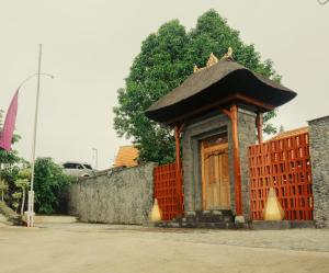 a small building with a roof on a street at Camaradvipa Retreat Munduk in Munduk