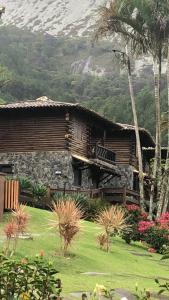 a house with a grass yard in front of it at Pousada Peterle in Domingos Martins