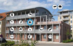 a building with clocks on the side of it at Hafendomicil Appartement WH11 - Eichhörnchen in Waren +1 photo