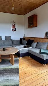 a living room with a couch and a table at Wald WG - Haus am Wald in Warmensteinach