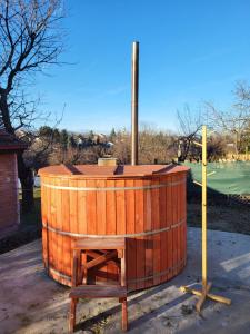a wooden barrel sitting on a stand next to a pole at Vila Mila Fruška Gora in Velika Remeta