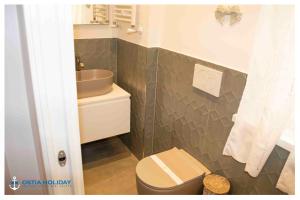 a bathroom with a toilet and a sink at Appartamento Executive Home in Lido di Ostia