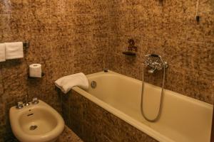a bathroom with a bath tub and a toilet at Brother's Home in Civitella Casanova +29 photos