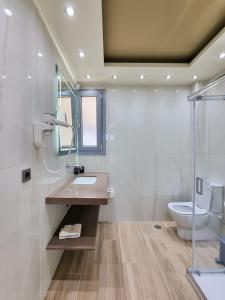 a bathroom with a sink and a toilet at XENIA LUXURY APARTMENTS CHIOS in Chios +26 photos