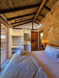 a bedroom with a bed with a towel on it at Tawa Caraíva in Caraíva +84 photos