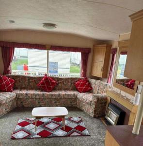 a living room with a couch and a table at Lovely 8 Berth Caravan In Skegness With Free Wi-fi, Ref 96023d in Skegness