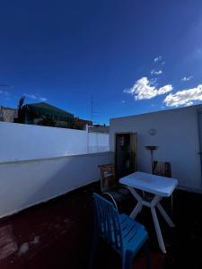 a table and a chair sitting on a balcony at Medina Stars in Rabat