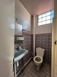 a bathroom with a toilet and a sink at Medina Stars in Rabat