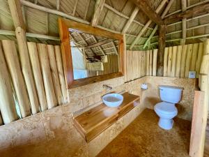 a bathroom with a toilet and a mirror at Rancho Romana Retreat N-05 in El Limón