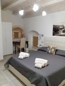 a bedroom with a large bed with two pillows on it at New Aurispa in Noto