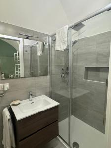 a bathroom with a sink and a shower at Corte Capuana in Catania