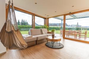 a living room with a couch and a hammock at Luxury Resort Potatoland in Šenčur