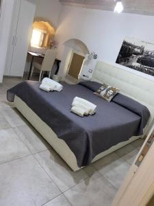 a bedroom with a large bed with two pillows on it at New Aurispa in Noto +20 photos