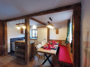 a dining room with a table and a kitchen at ALMNEST - LACHTAL in Lachtal