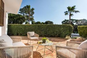 a patio with chairs and a table at PEAR TREE VILLA in Vale do Lobo