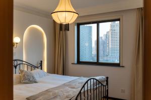 a bedroom with a bed and a window at Yi Du Home with City View - Family Suite 500m to Nanjing West Rd Near People's Square -Credit Cards Accepted in Shanghai