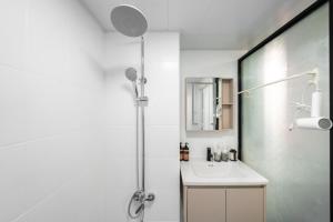 a bathroom with a shower and a sink at Shanghai Yi DU Apartments Downtown - near Nanjing West Road subway in Shanghai