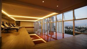 a room with a balcony with a view of a city at Quartos no QS Marista in Goiânia
