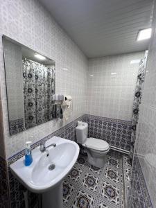 a bathroom with a sink and a toilet at Rumi Hotel & Hostel in Bukhara