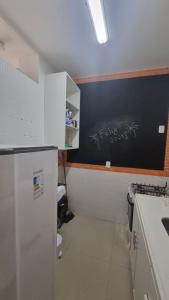 a kitchen with a blackboard with graffiti on the wall at Apê in Copacabana in Rio de Janeiro